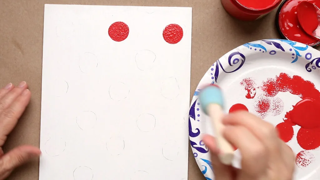 Using a pouncer add red polka dots inside the traced lines on the white side of the door hanger