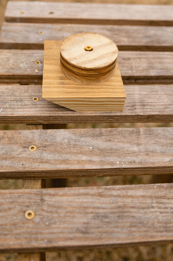 Bottle cover with wooden plug on a wooden work table outside 