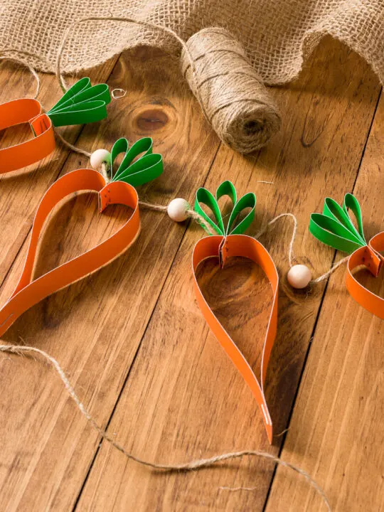 Carrot garland on a wood table with burlap