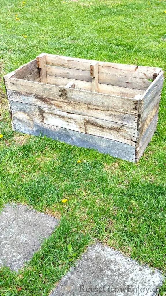 pallet wood raised bed sitting in grass