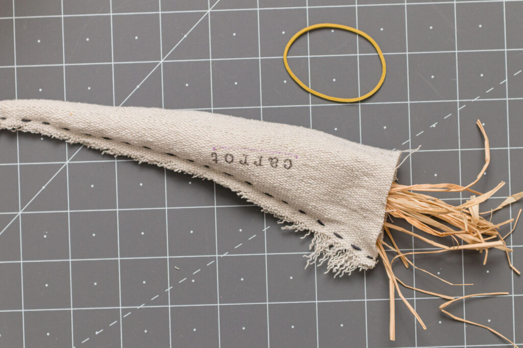 Insert raffia into the open end of the carrot