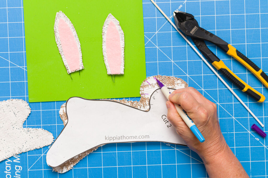 Using an air soluble maker and the pattern as a guide to mark the placement of the ears 