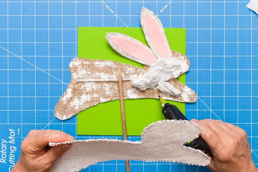 Adding pieces of the crinkled paper bag to the bunny's head and front leg 