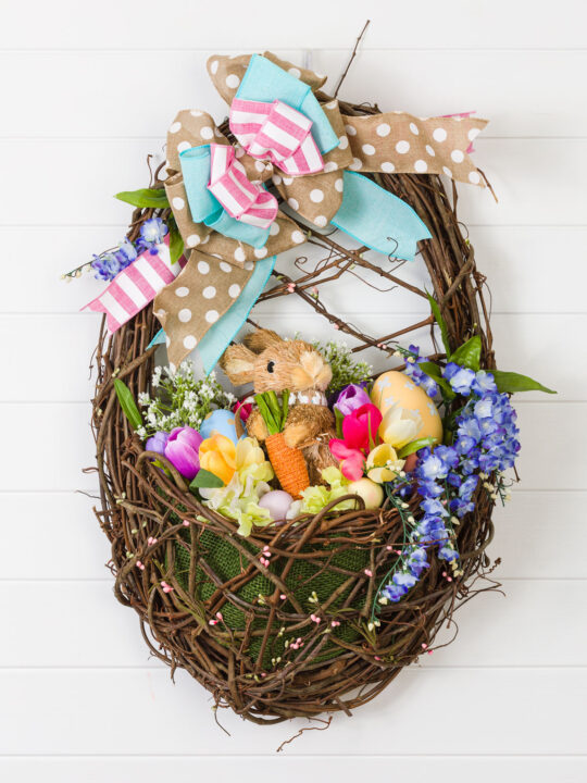 Wreath basket filled with Easter decorations and a bow