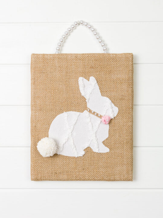 Burlap and pearls bunny wall art hanging on a wall 