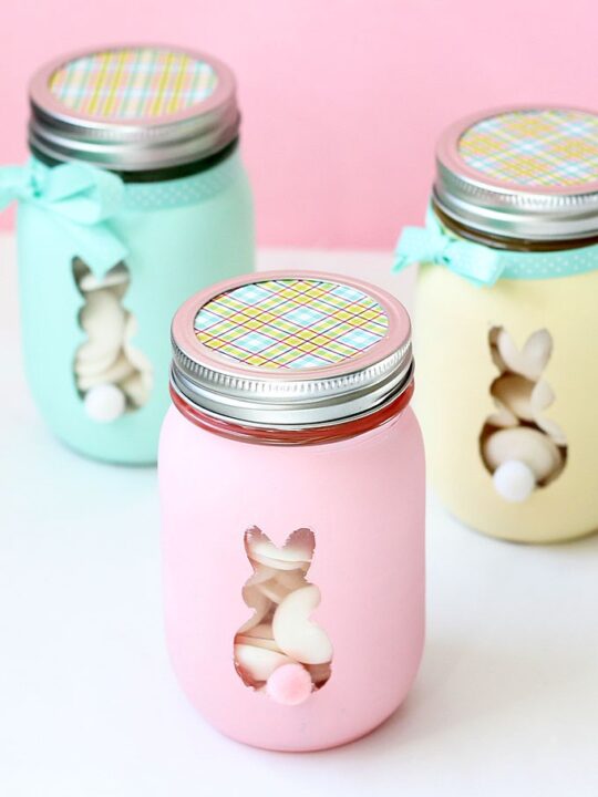 Three pastel painted Easter Bunny Mason Jars filled with candy 