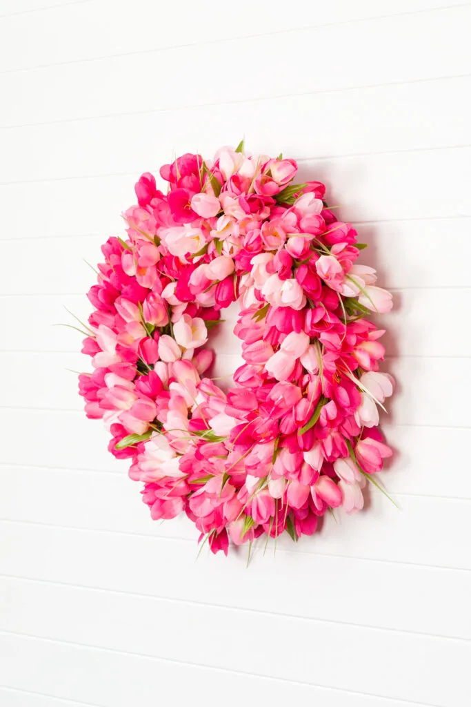 Side view of the tulip wreath hanging on a white wall