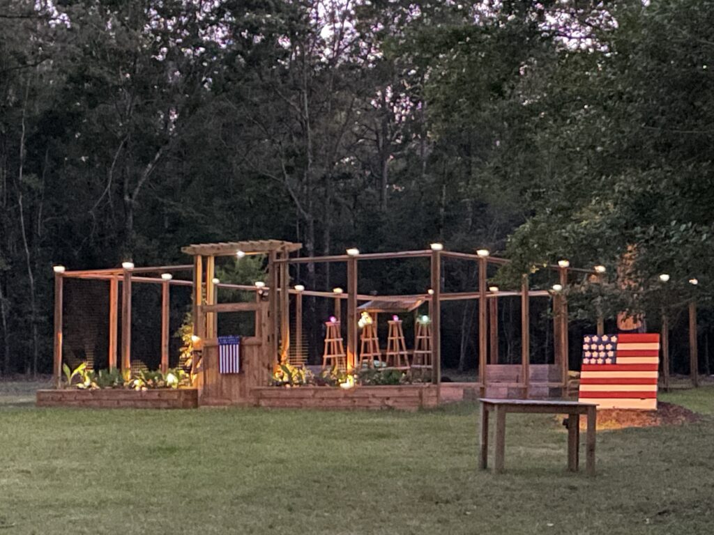 Night view of the garden decorated with American flag pallet signs