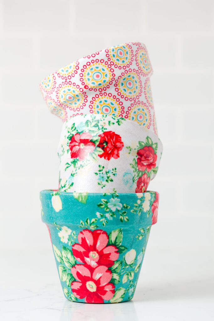 three fabric covered flower pots stacked