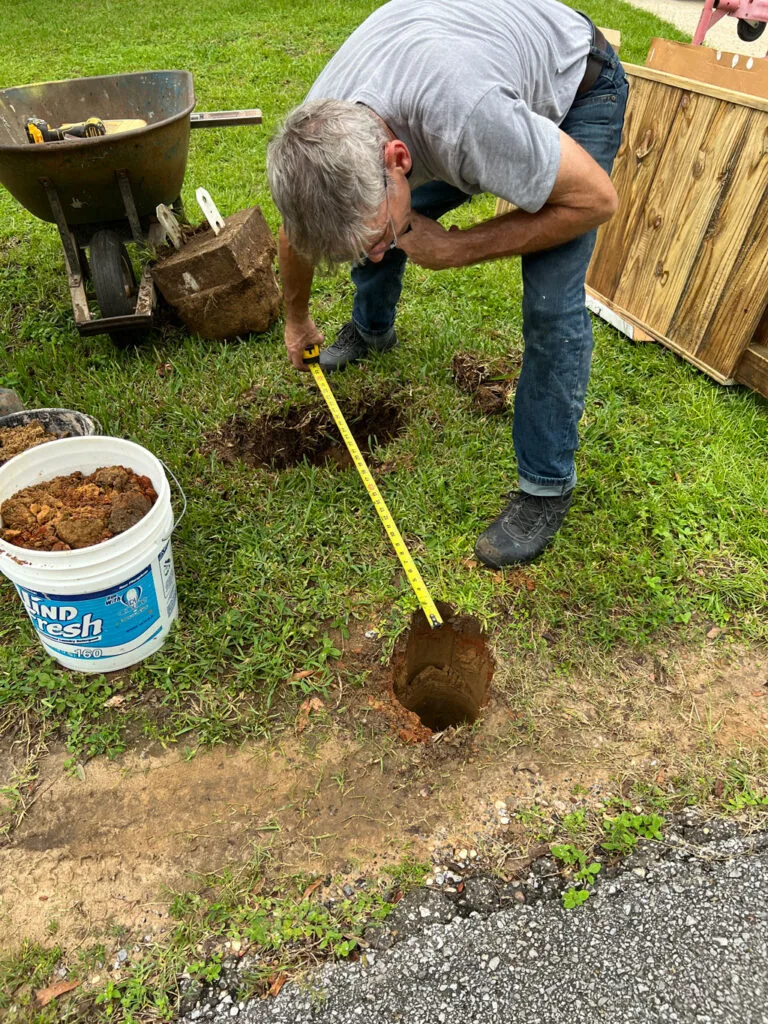 Measuring the distance between the post holes for installation 