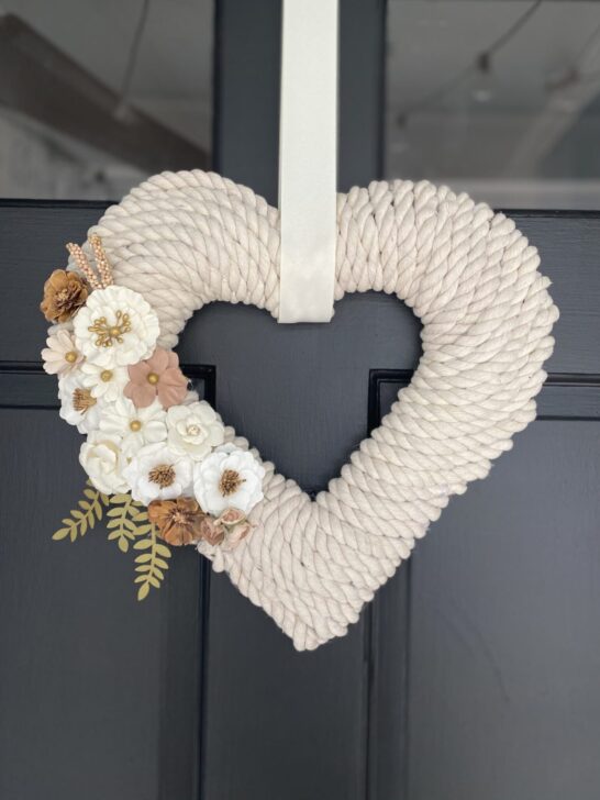 Cream colored rope heart shaped wreath with while flowers