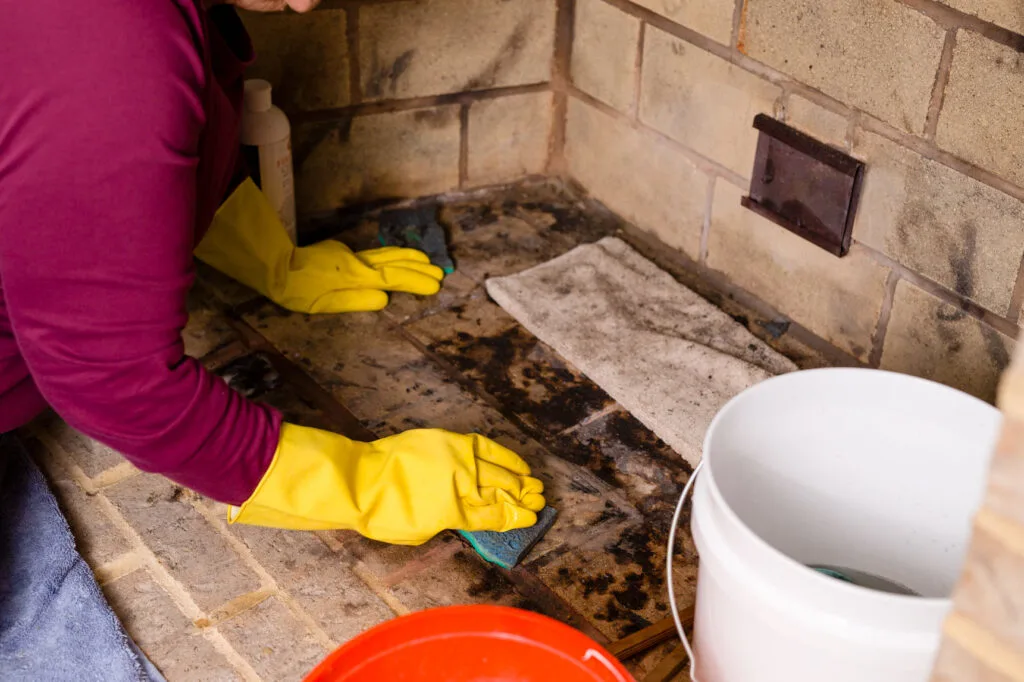 cleaning the firebox with a sponge