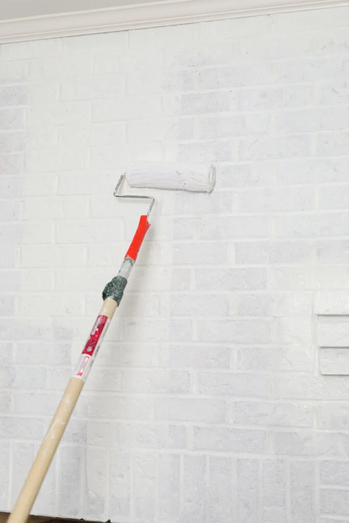 Painting brick with a roller and white paint