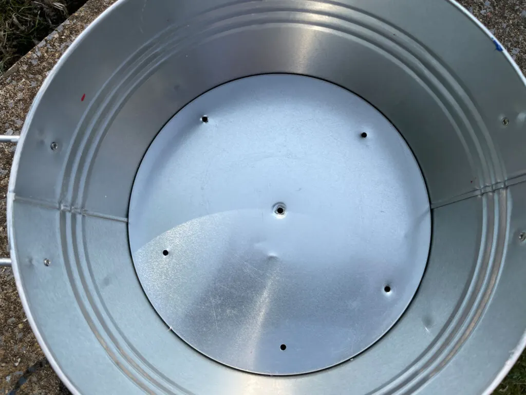 Galvanized container with holes drilled in the bottom 