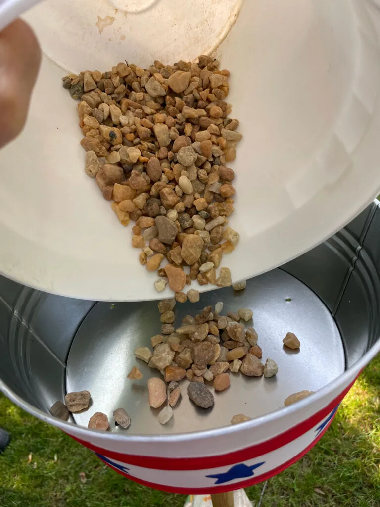 Pouring rocks into the container