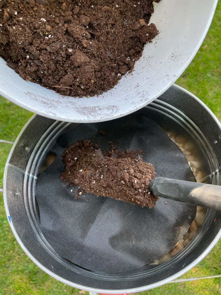 filling the diy planter with garden mix