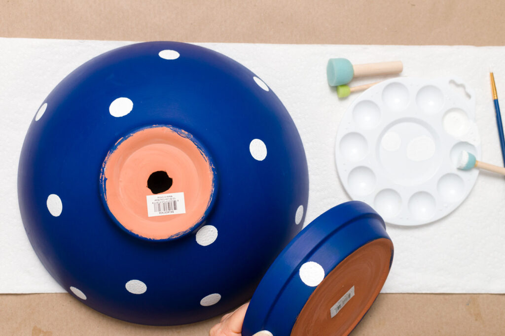 Adding white polka dots to the blue painted saucer