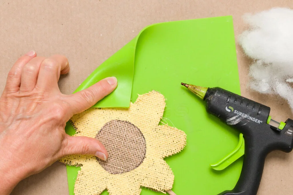 Using a silicone mat to push the hot glued pieces together