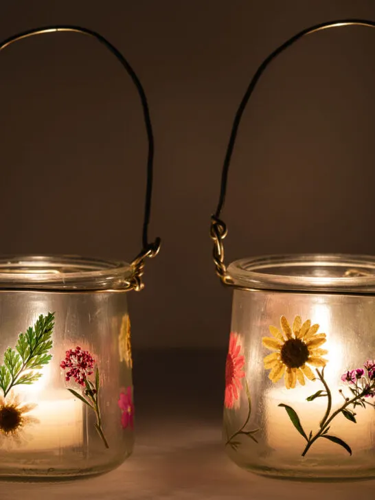 two pressed flower lanterns with candles