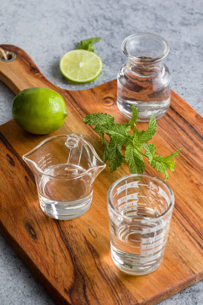 mojito recipe ingredients on a wood cutting board