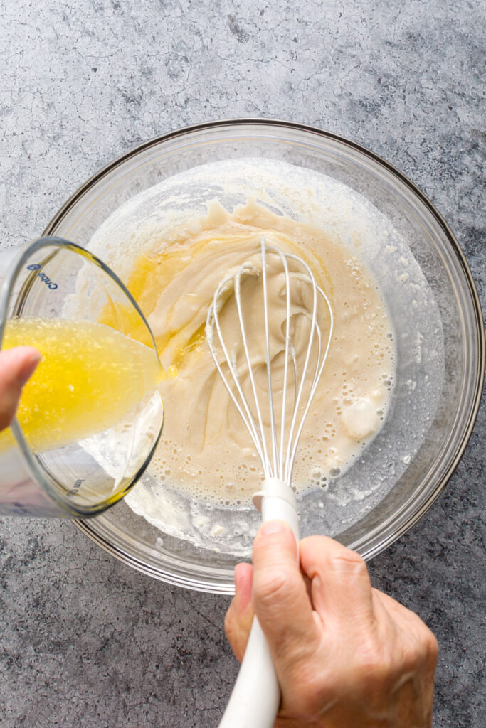 Adding melted butter to the flour mixture
