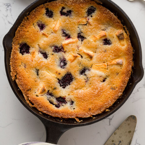 Iron pan with blackberry cobbler on a table