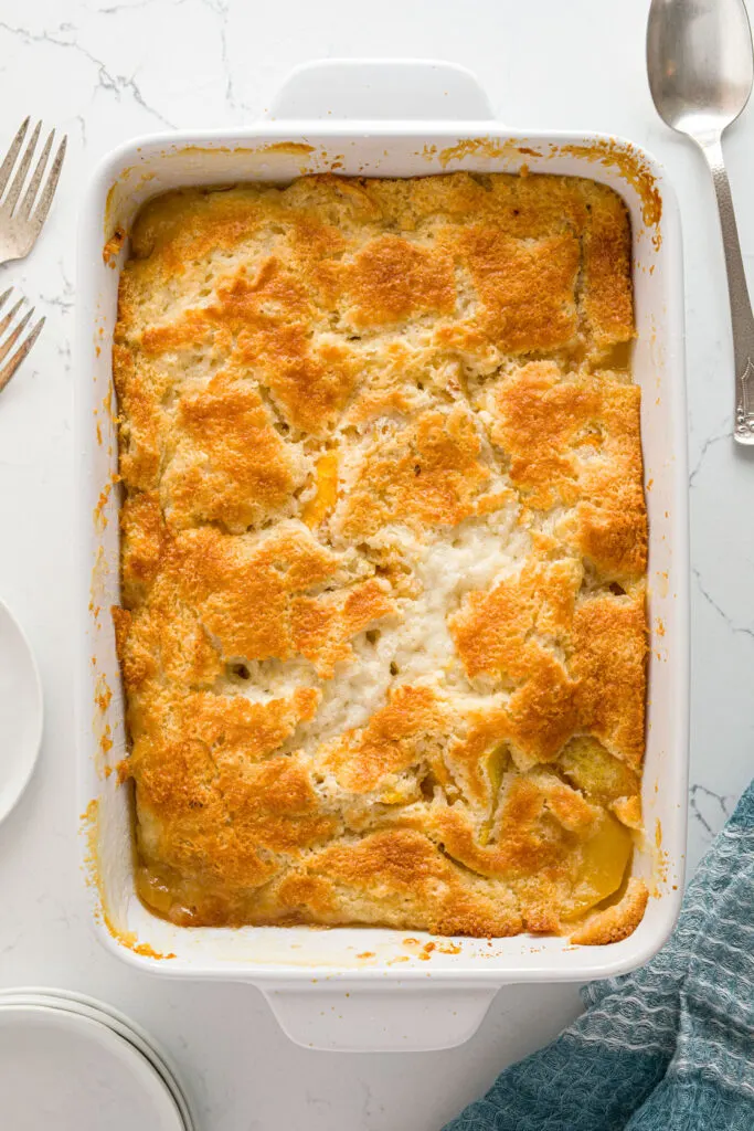 Casserole dish with homemade peach cobbler