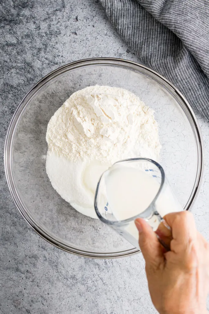 Pour milk over flour, sugar, baking powder in a bowl