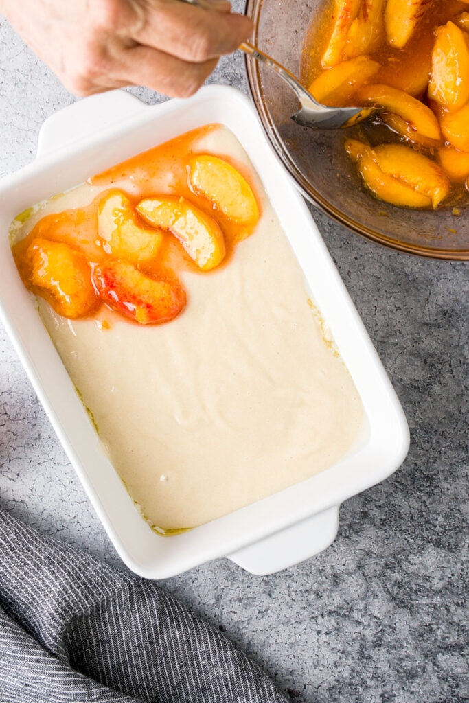 Top the batter with peach slices