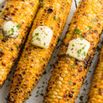 grilled corn on the cob on a plate