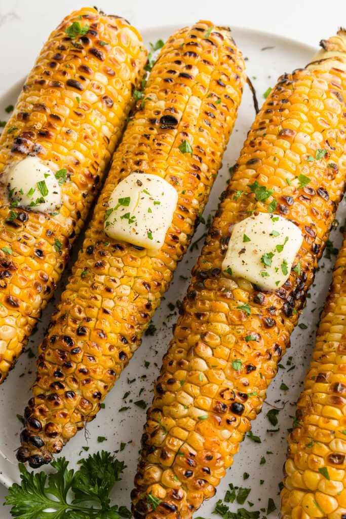 grilled corn on the cob on a plate
