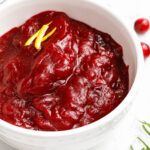 Cranberry Sauce in a bowl with orange zest garnish
