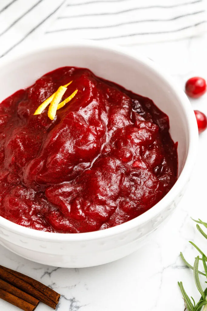 Cranberry Sauce in a bowl with orange zest garnish