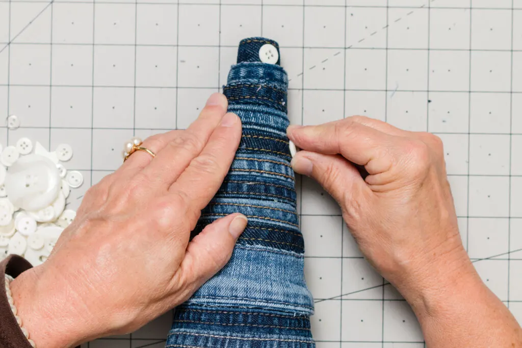 Decorating the blue jean tree with buttons