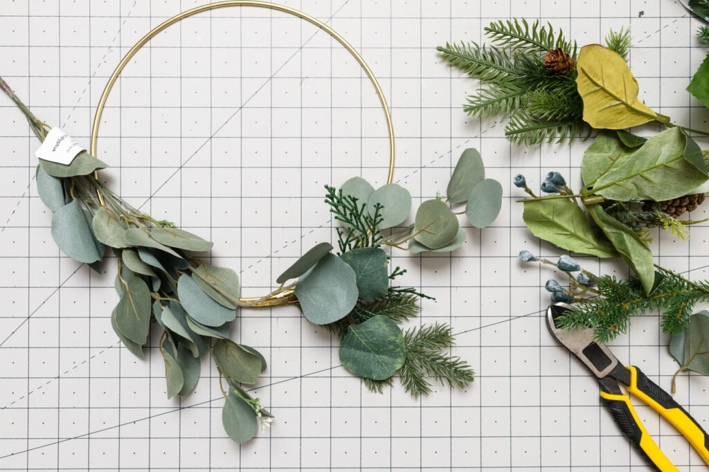 Attaching greenery to a metal hoop