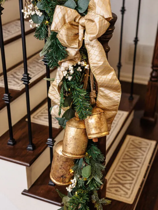 Banister with greenery, ribbon and bells