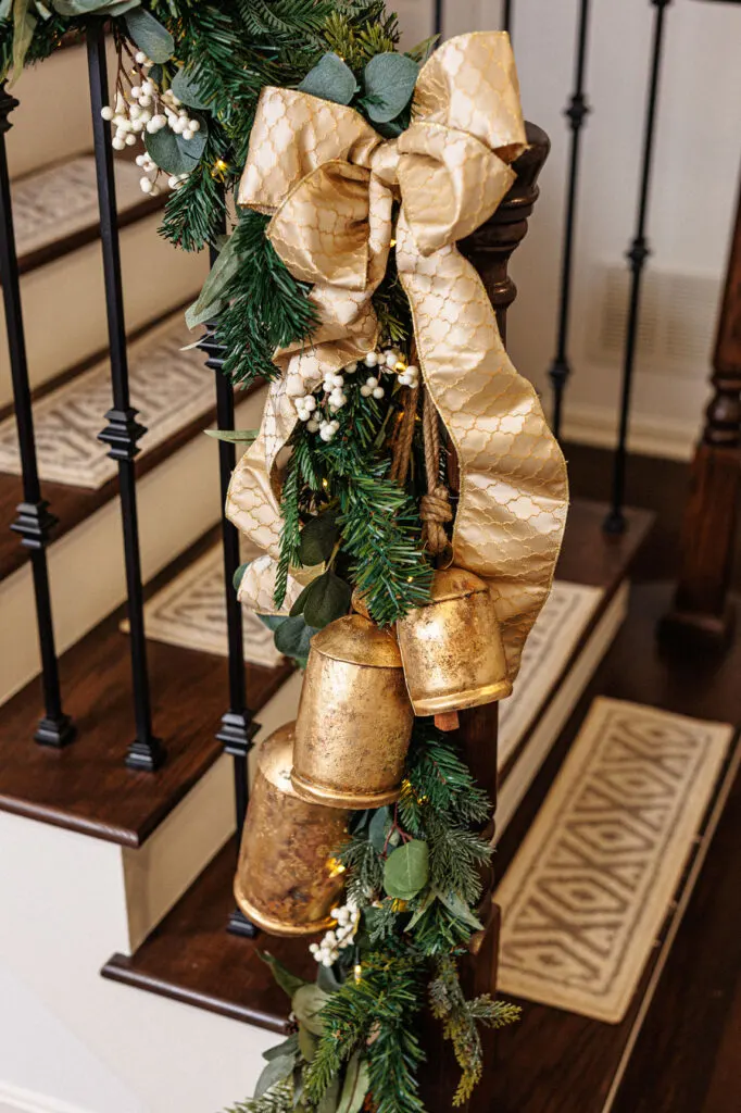 Banister with greenery, ribbon and bells