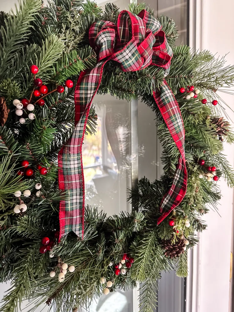 Traditional evergreen wreath with a plaid ribbon bow