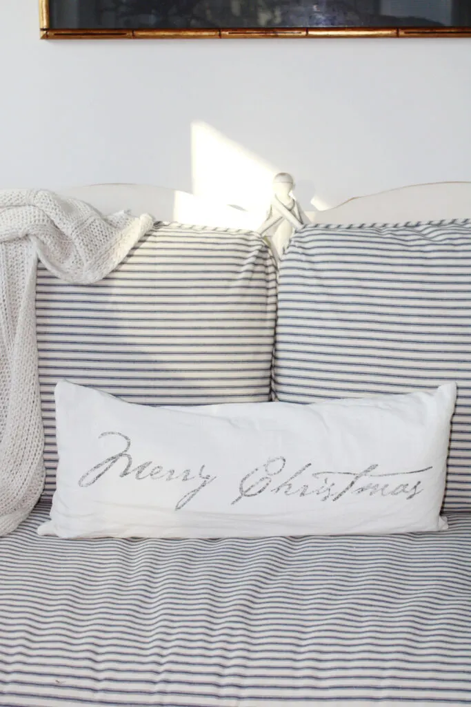 comfy Christmas pillow on a sofa 