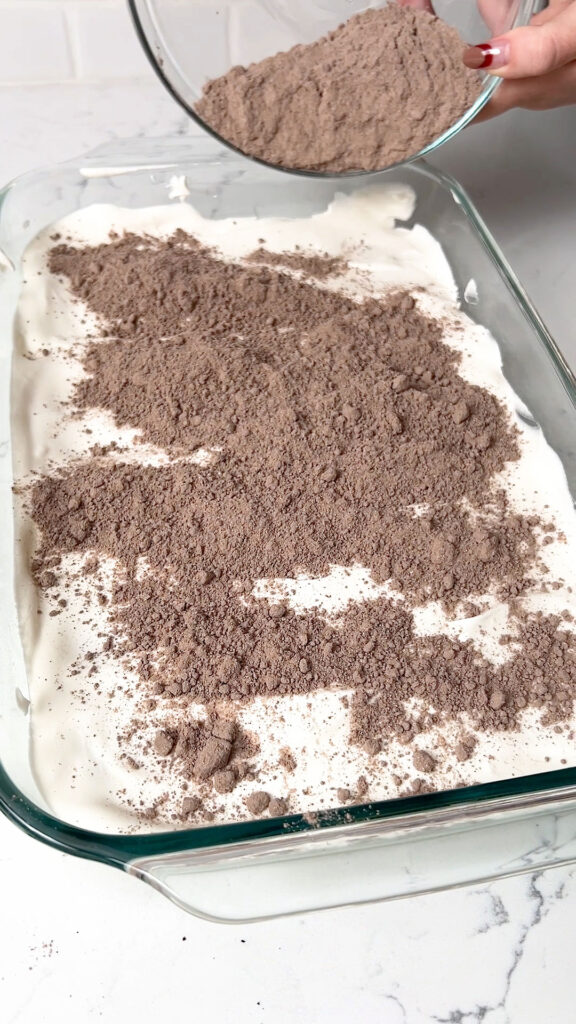 Sprinkling on the dry cake mix over the whipped topping