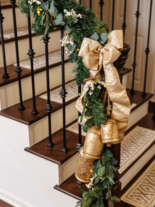stairway with Christmas greenery, bow and bells