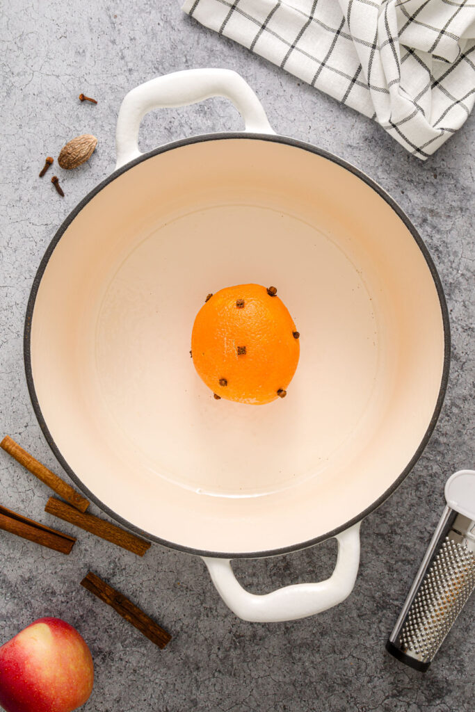 Orange with cloves in a Dutch oven