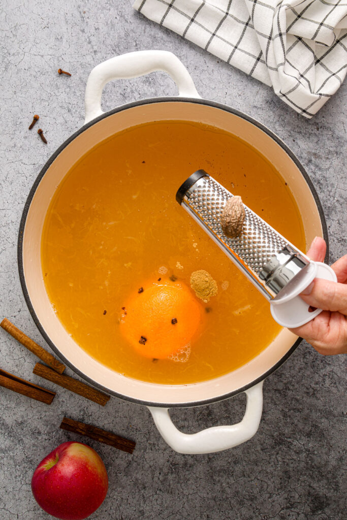 Grating nutmeg into Wassail pot