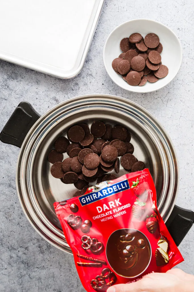 Adding chocolate wafers into the double boiler