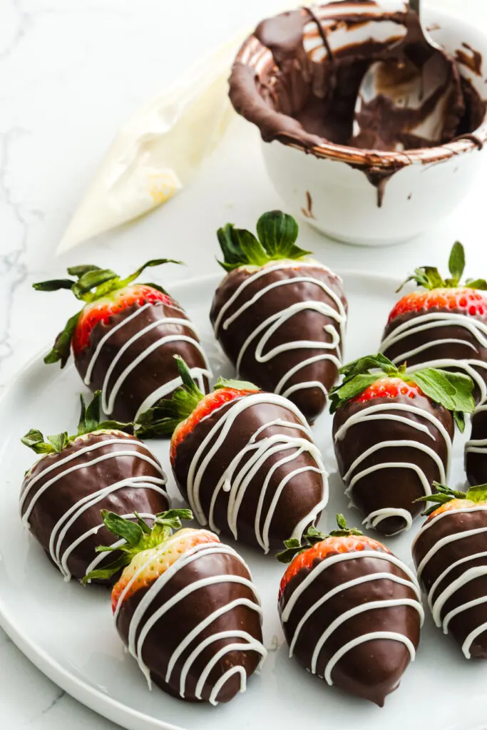dark chocolate covered strawberries with white chocolate stripes