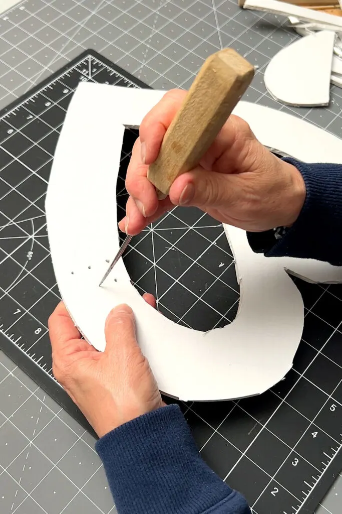 Poking holes in the foam board heart with an ice pick