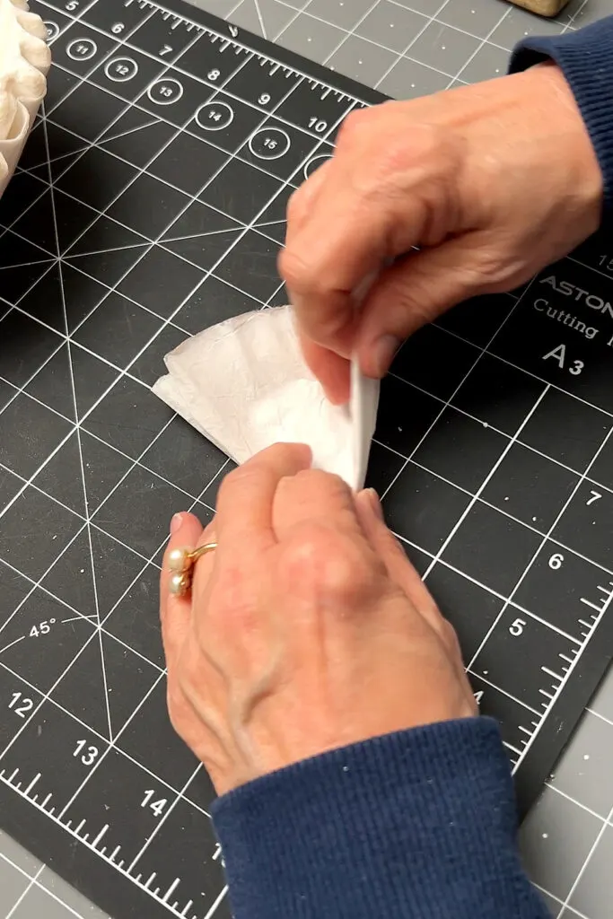 folding a coffee filter on a craft mat