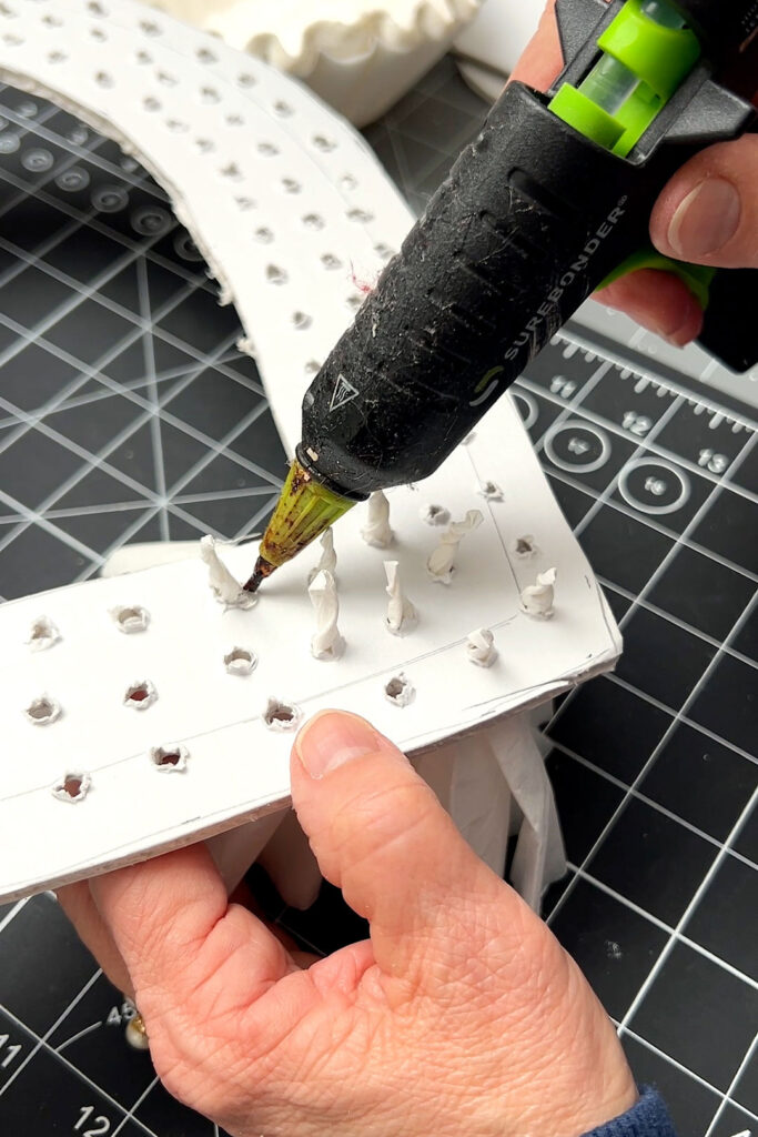 Gluing the back side of the inserted coffee filters with hot glue 