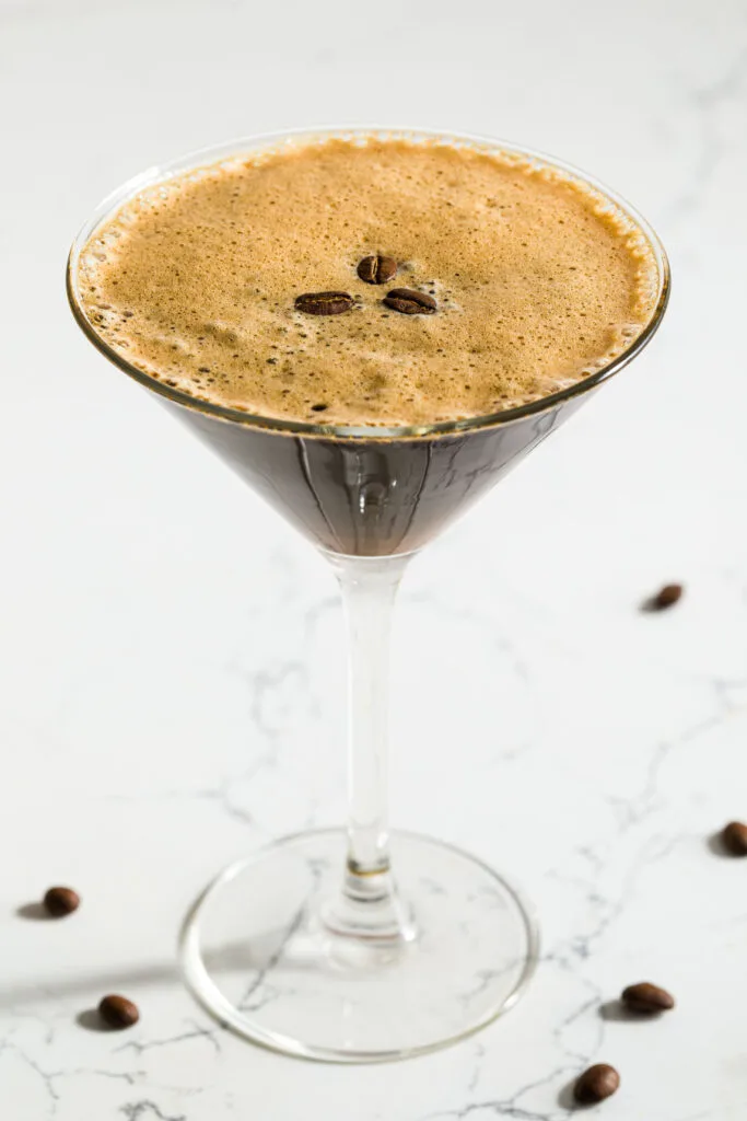 espresso martini sitting on a white quartz countertop