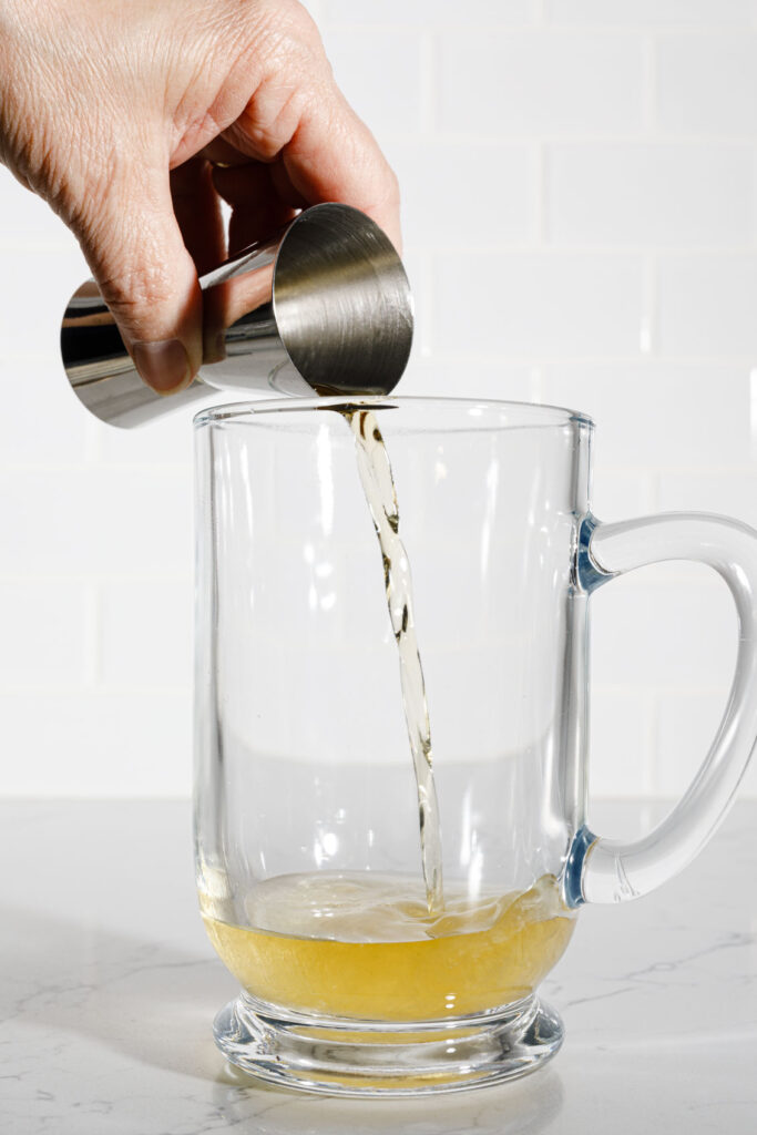 Pouring Jameson Irish Whiskey in to glass mug